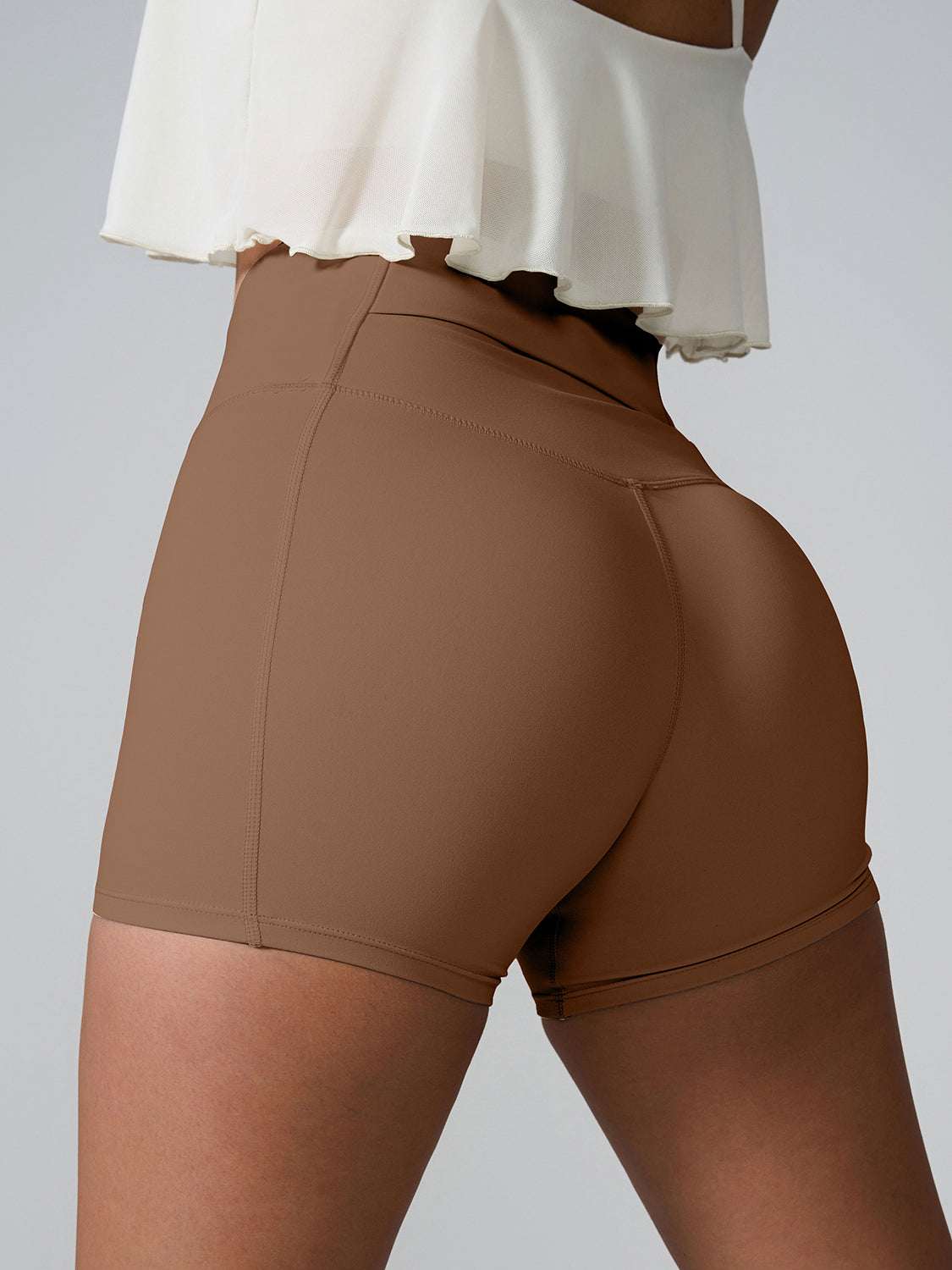 High Waist Active Shorts with pockets in brown, made from stretchy nylon and spandex.