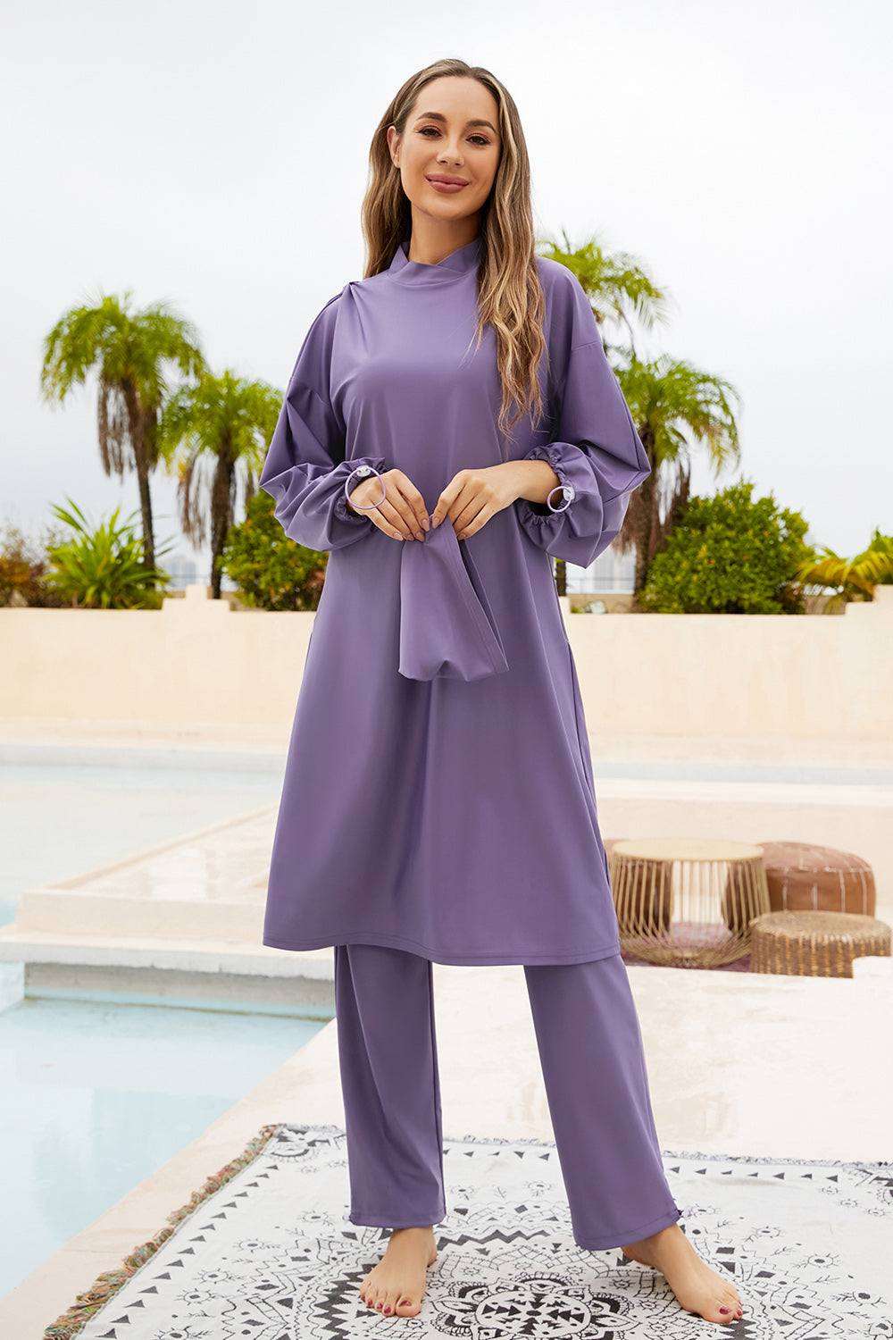 Cap, drawstring mock neck swim set with long sleeves and pants in purple, highly stretchy fabric.