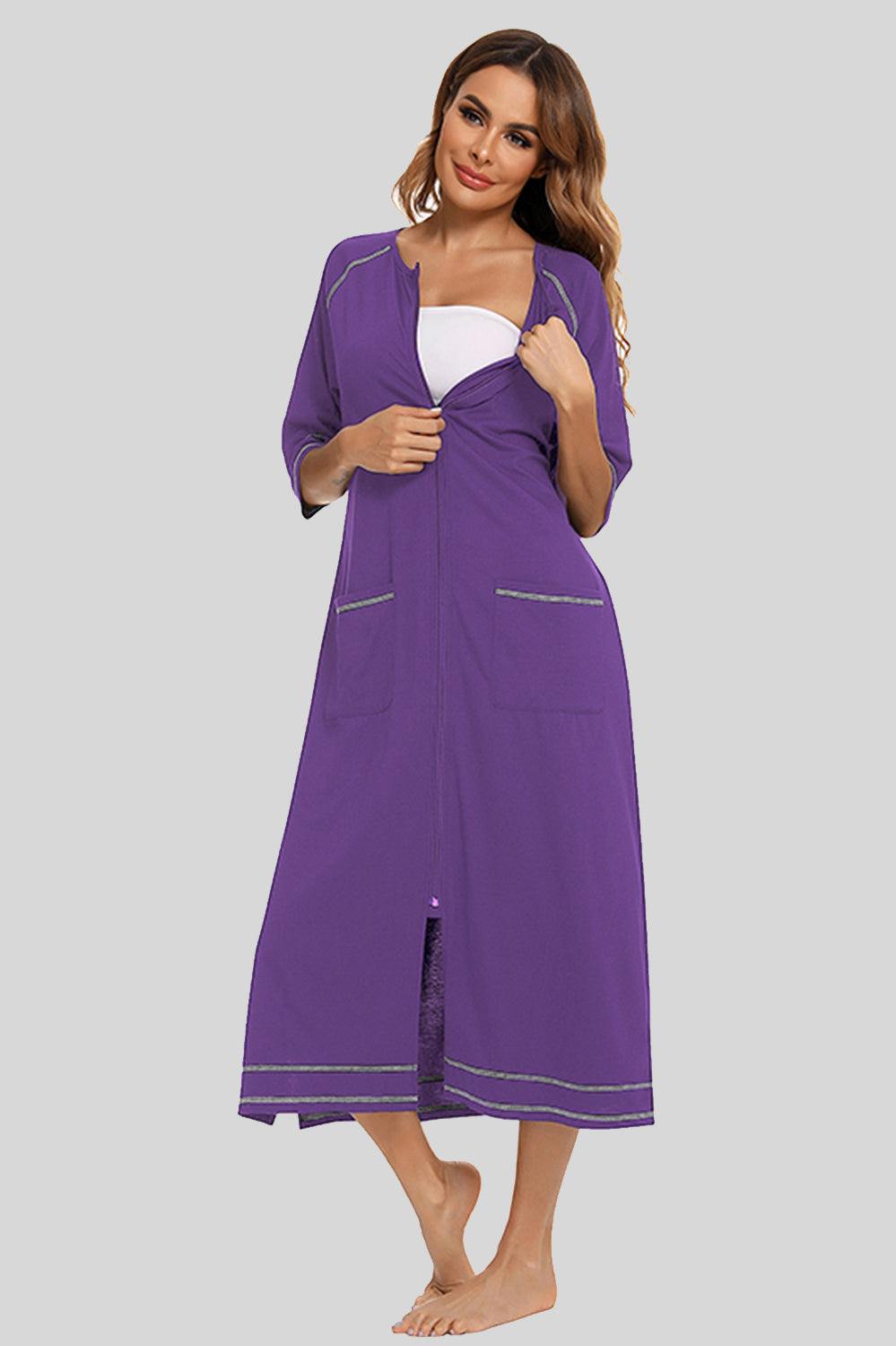 Round neck night dress with slit, pockets, and zip-up front in purple.