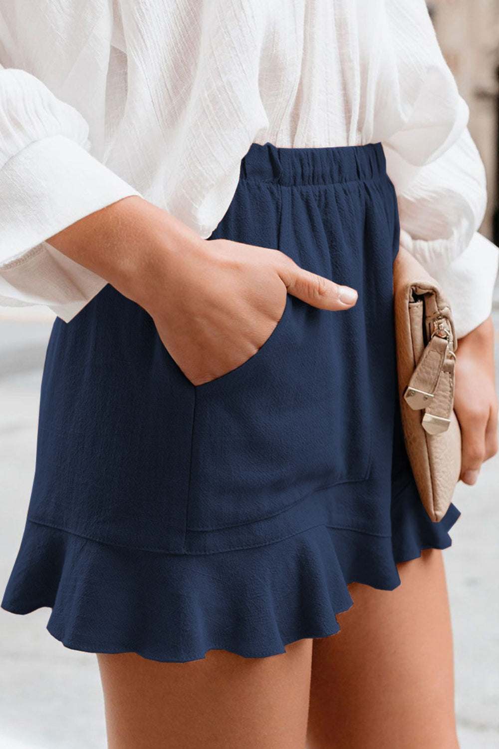 Full Size Ruffled Elastic Waist Shorts in navy blue featuring a casual ruffled hem style.