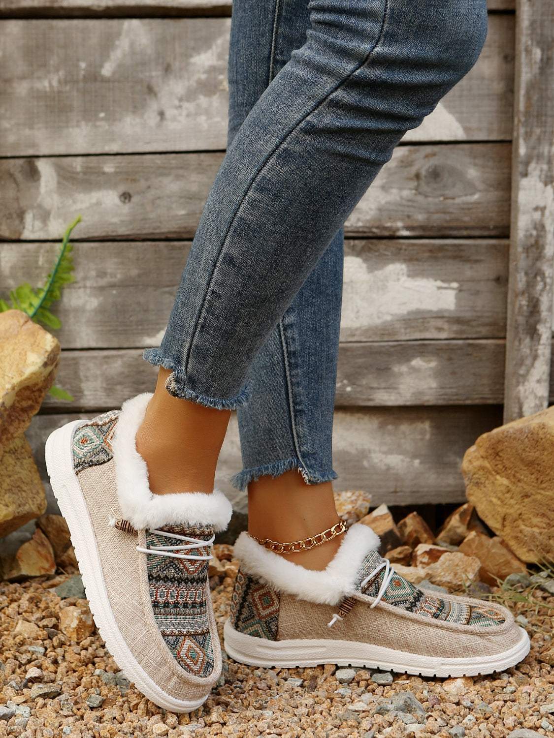 Women's printed round toe flat slip-ons with faux fur lining and textured design.