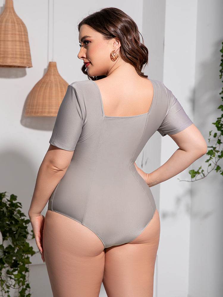 Plus size scoop neck short sleeve one-piece swimsuit, solid color, stretchy material.