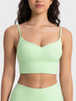 Millennia Spaghetti Strap Sport Bra in light green, featuring removable padding and stretchy nylon-spandex fabric.