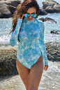 Printed mock neck long sleeve one-piece swimwear on model by the beach.