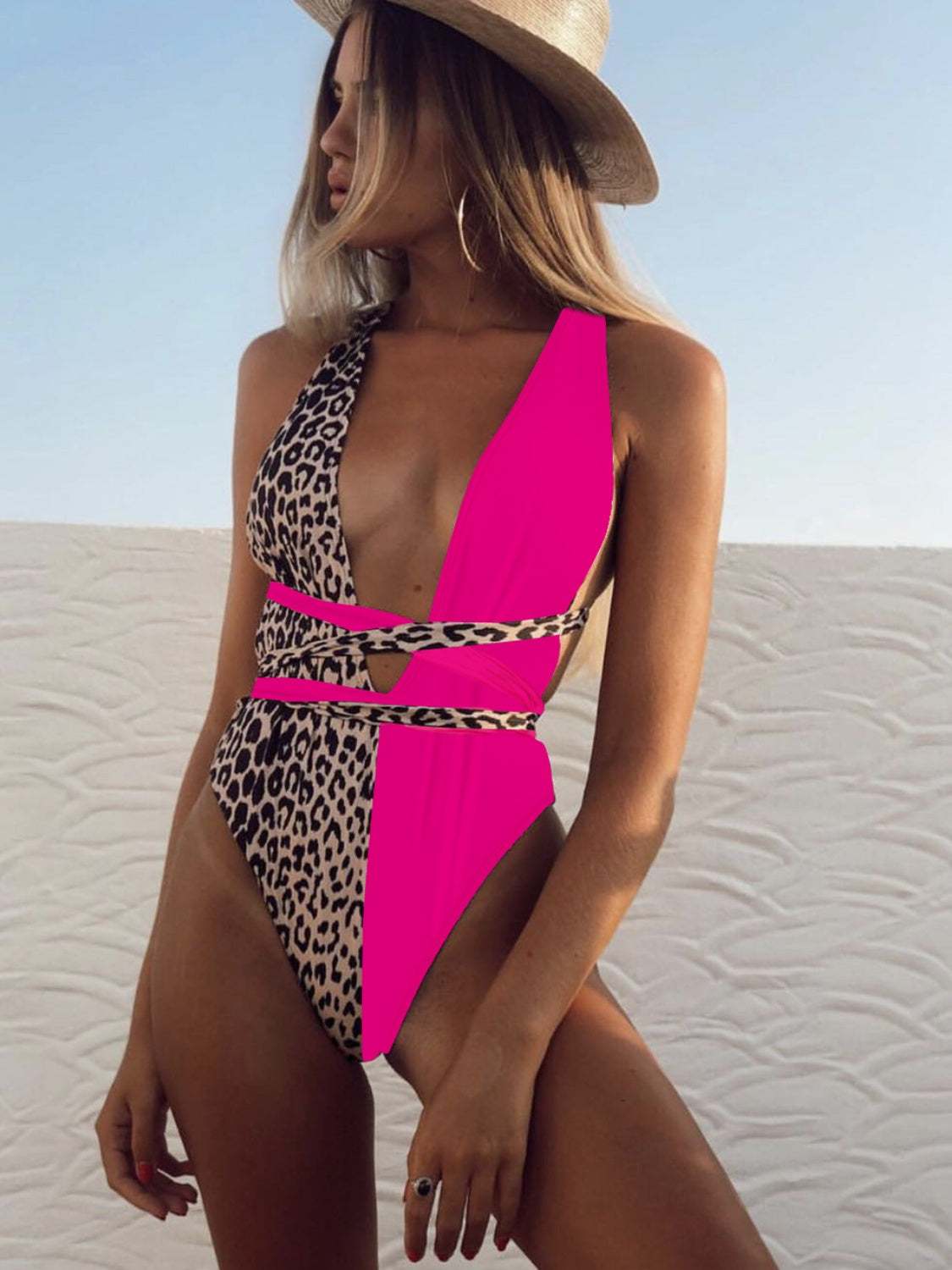 Woman wearing a Tied Leopard Plunge One-Piece Swimwear with a V-neck design and removable padding.