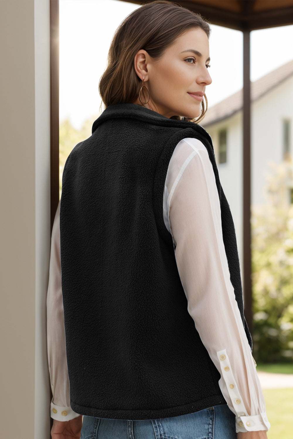 Black zip-up vest coat with pockets, polyester spandex blend, women's outerwear.