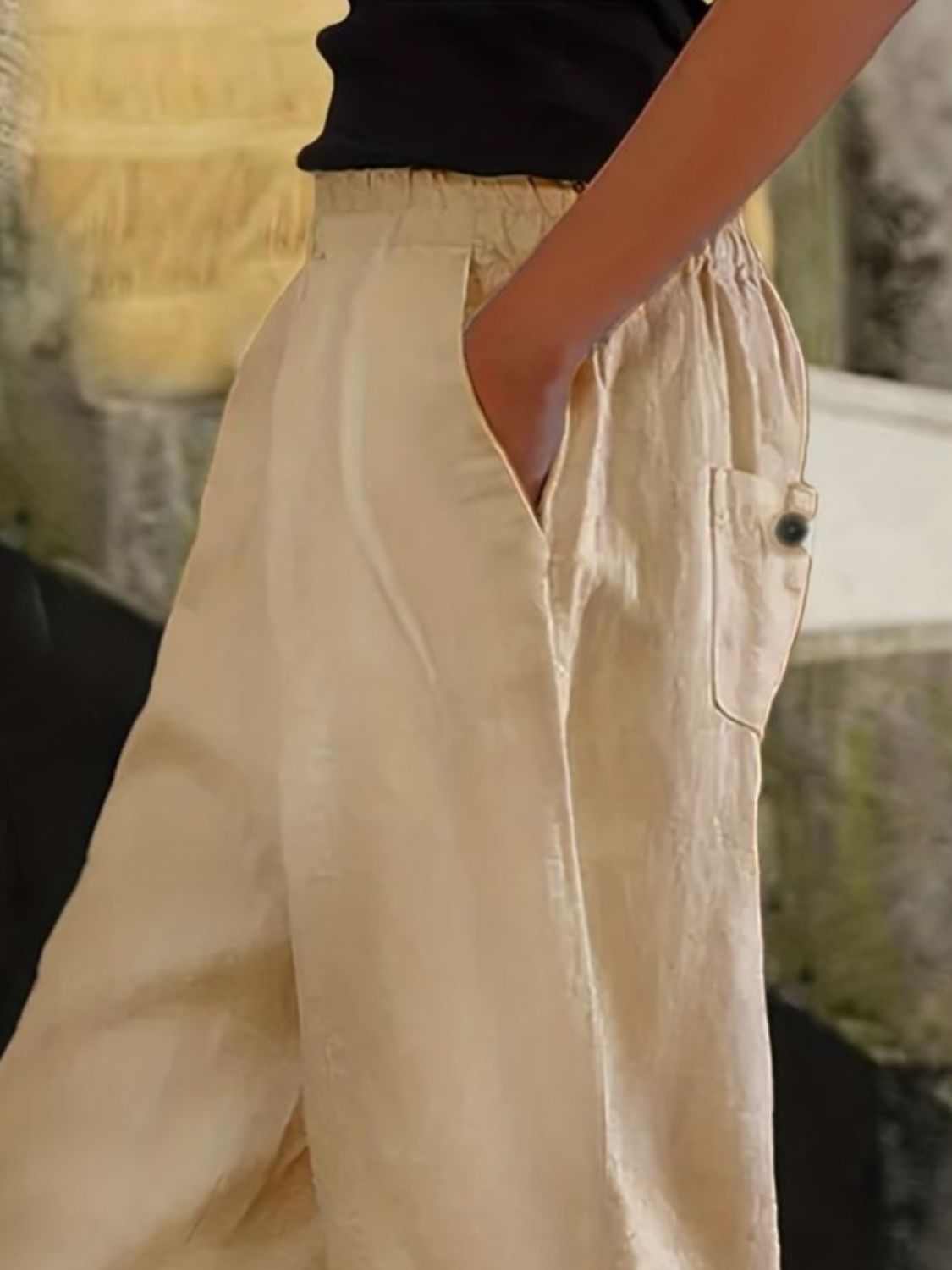 Plus size wide leg pants with pockets in beige, featuring button details.