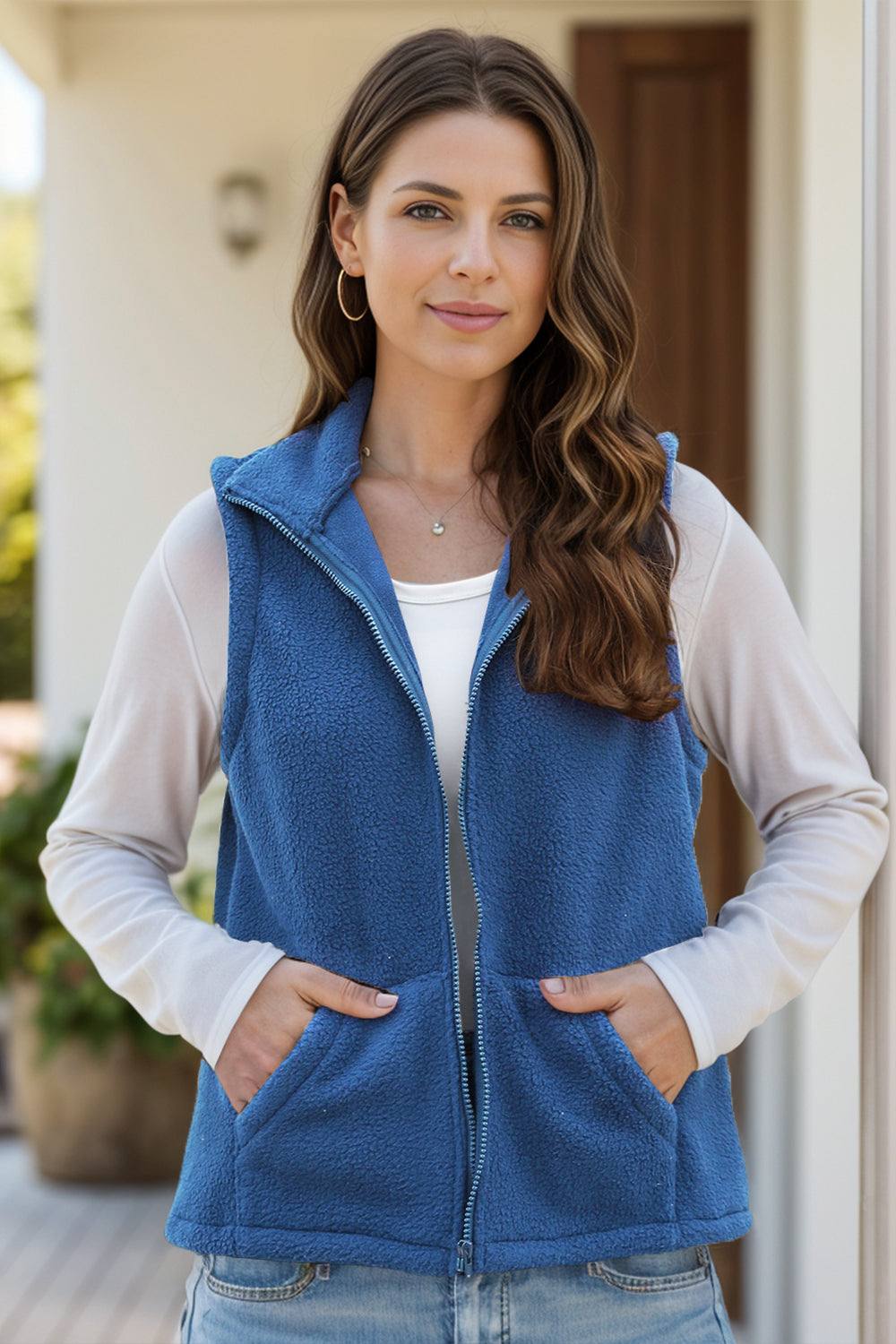 Blue zip up vest coat with pockets, women's outerwear, polyester and spandex mix.