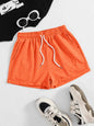 Orange drawstring pocketed elastic waist shorts made of polyester.