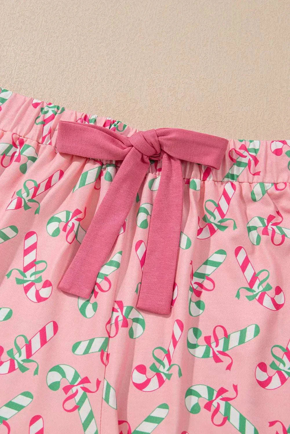 Pink shorts with candy cane print and pink ribbon tie, part of the Candy Cane Collared Neck Top and Shorts Lounge Set.