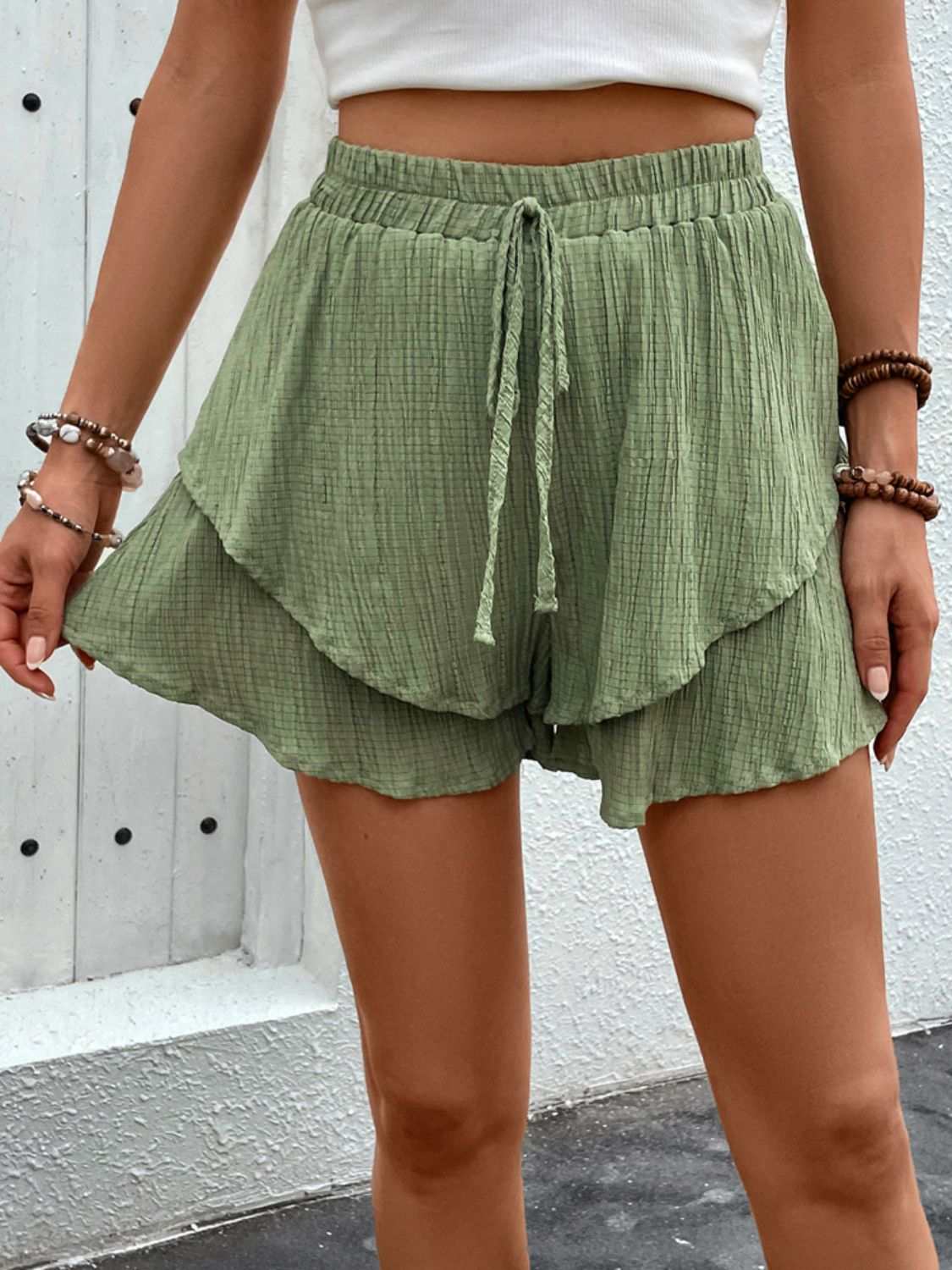 Green tied layered high waist shorts with ruffled design.