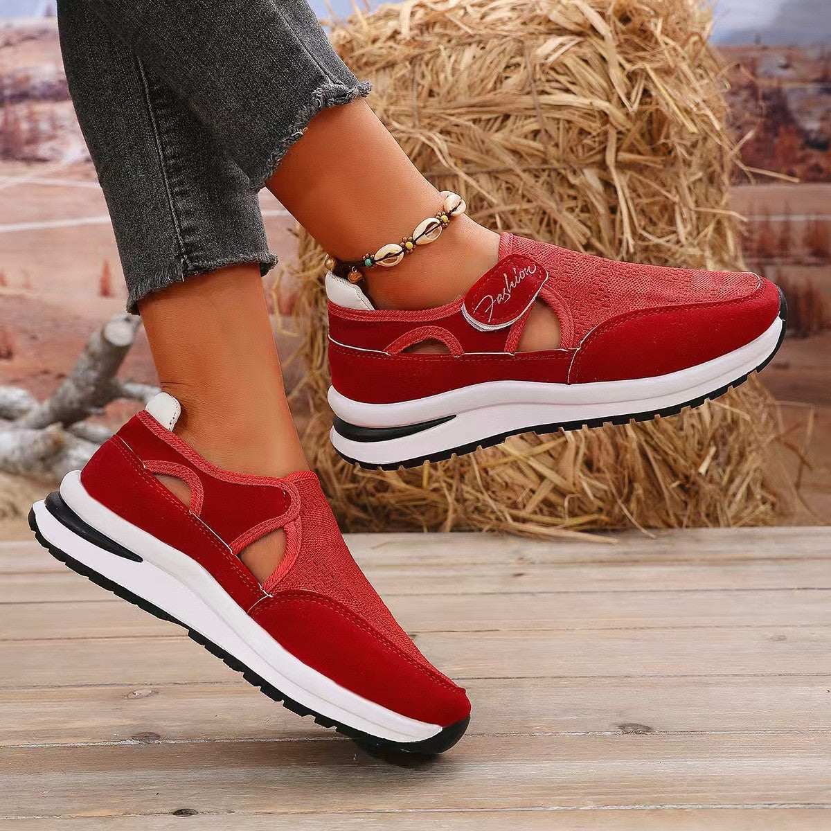 Red mesh round toe platform sneakers with mid heels and woven PU leather material.