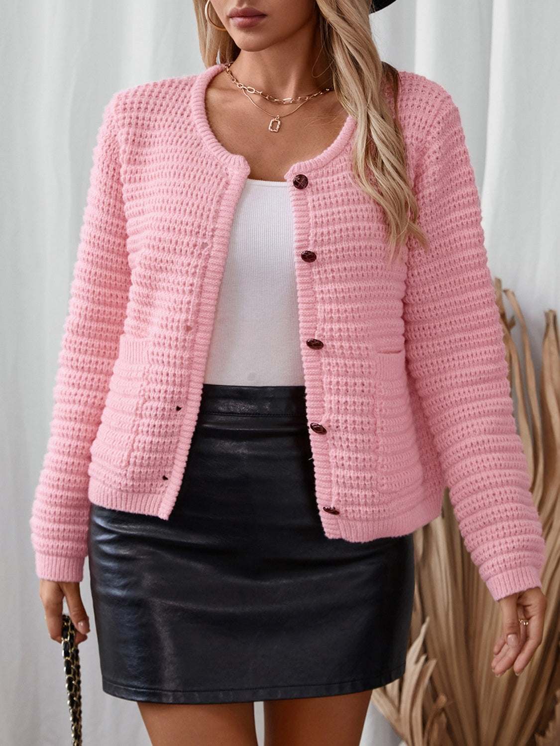 Pink button-up long sleeve cardigan with pockets.