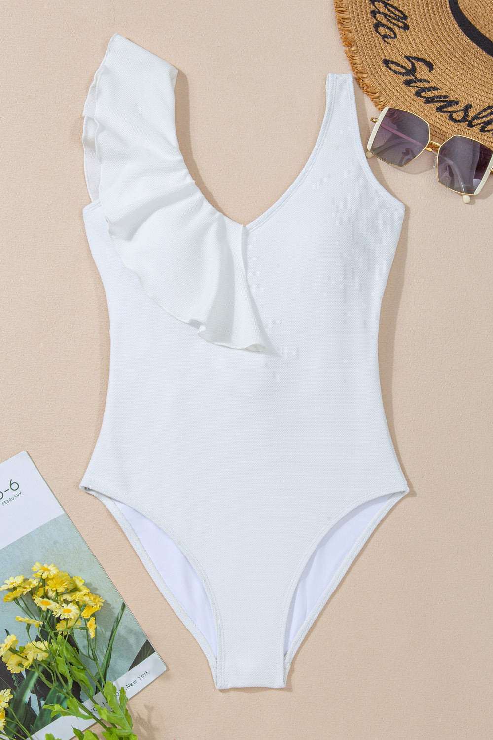 Ruffled V-neck one-piece swimwear with wide straps, featuring removable padding and stretchy polyester blend.