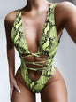 Backless plunge one-piece swimwear with lace-up design and snake print.