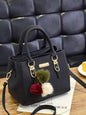 women's handbag with pom-poms on table, all-match shoulder bag