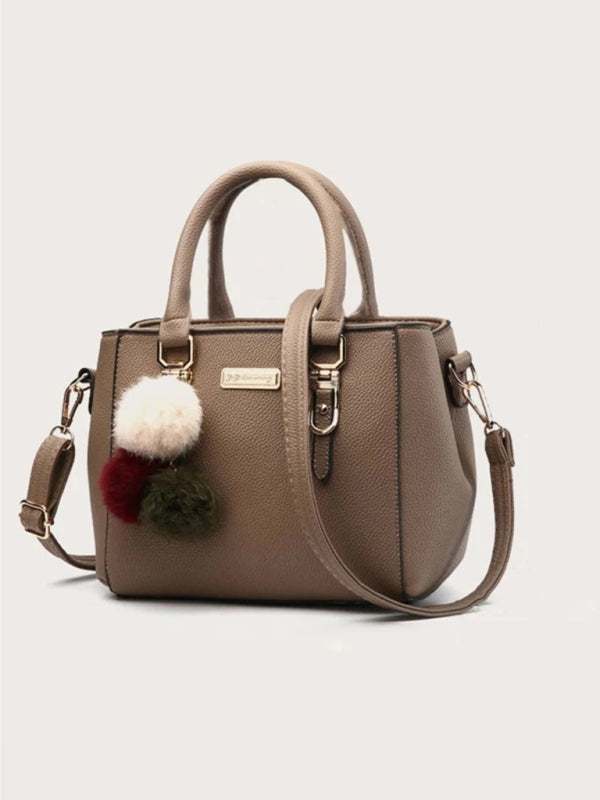 Women's handbag fashion all-match shoulder bag in brown PU with pompom accessory.