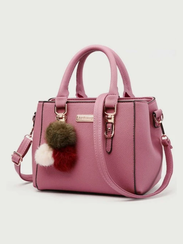 Women's pink all-match shoulder bag with handle and colorful pom-pom accessory.