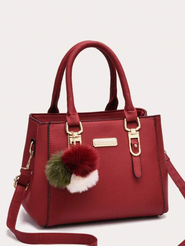 Women's red PU all-match shoulder handbag with decorative pom-poms.